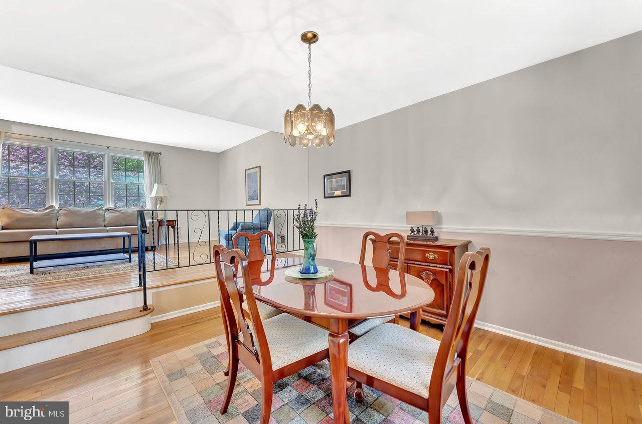 79 Wolfpack Road Hamilton, NJ 08619 - Photo 6 of 30 a dining room with furniture a chandelier and wooden floor