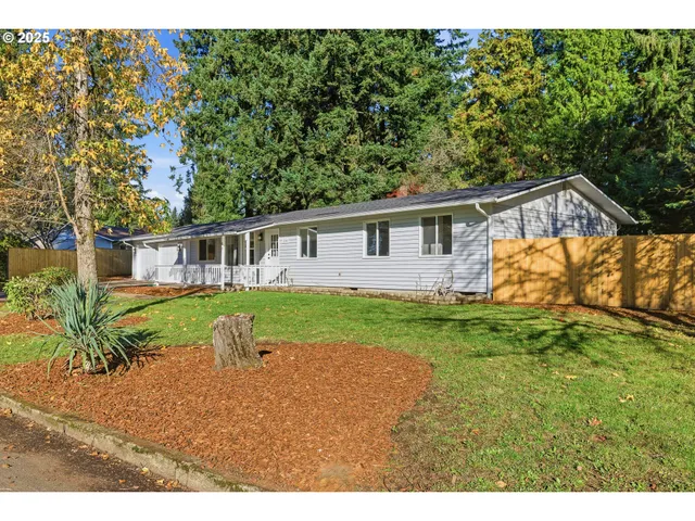 a view of house with backyard and garden