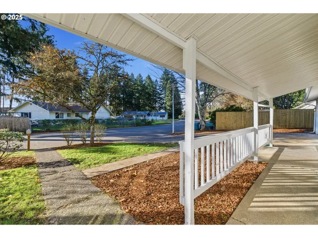 a view of a porch with wooden floor and fence