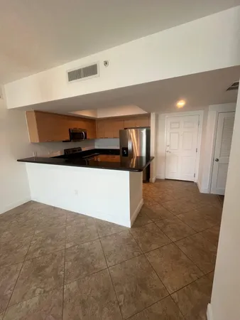 a kitchen with stainless steel appliances a sink and a stove
