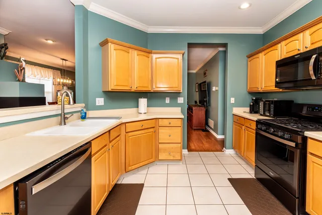 a kitchen with stainless steel appliances granite countertop a sink and a stove