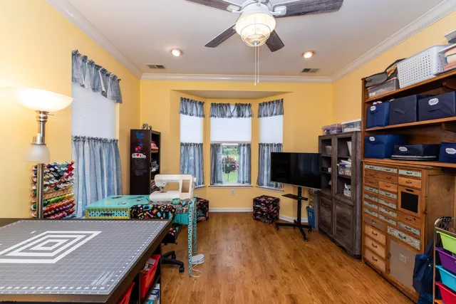 a view of a workspace with furniture and a flat screen tv