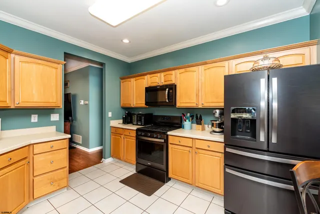 a kitchen with granite countertop cabinets stainless steel appliances and a window