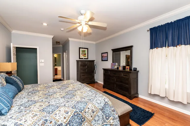 a bed room with a bed and a mirror on dresser