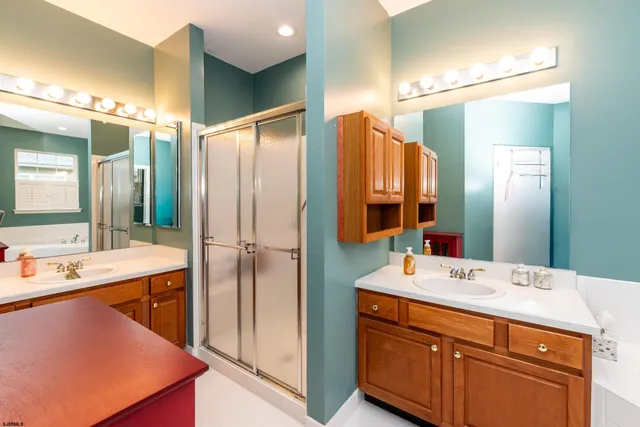 a bathroom with a double vanity sink mirror and double