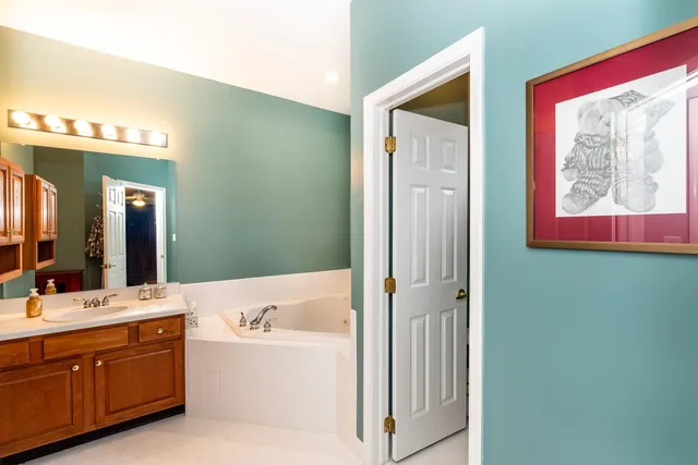 a bathroom with a bathtub sink and mirror