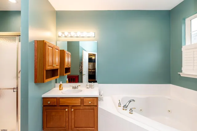 a bathroom with a bathtub sink and a mirror