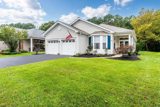 a view of a house with a yard and sitting area