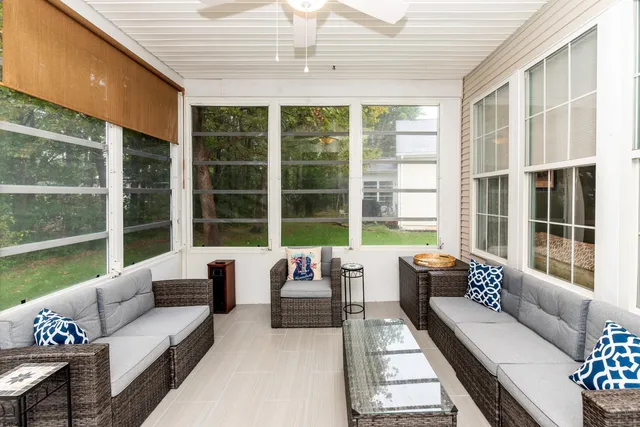 a living room with furniture and floor to ceiling windows