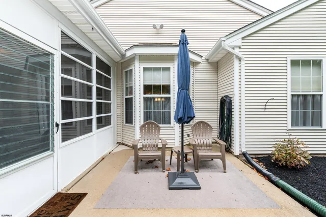 a view of a house with backyard and a tree