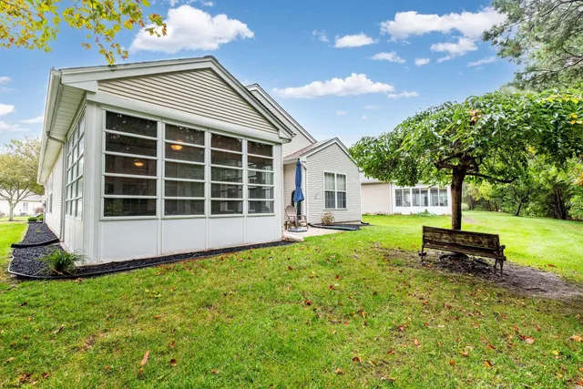 a view of a house with backyard and garden