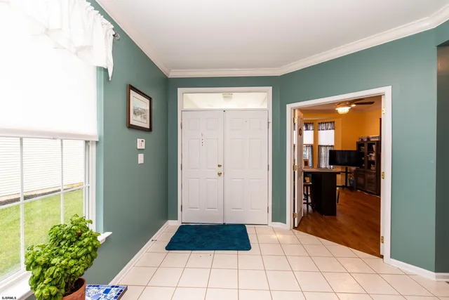 a view of a hallway and an dining rom with furniture
