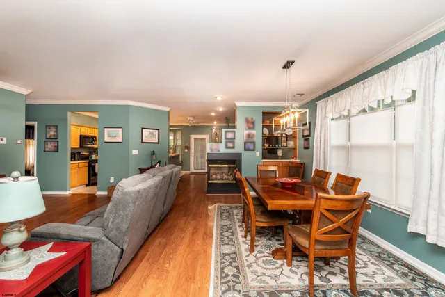 a dining room with furniture and wooden floor