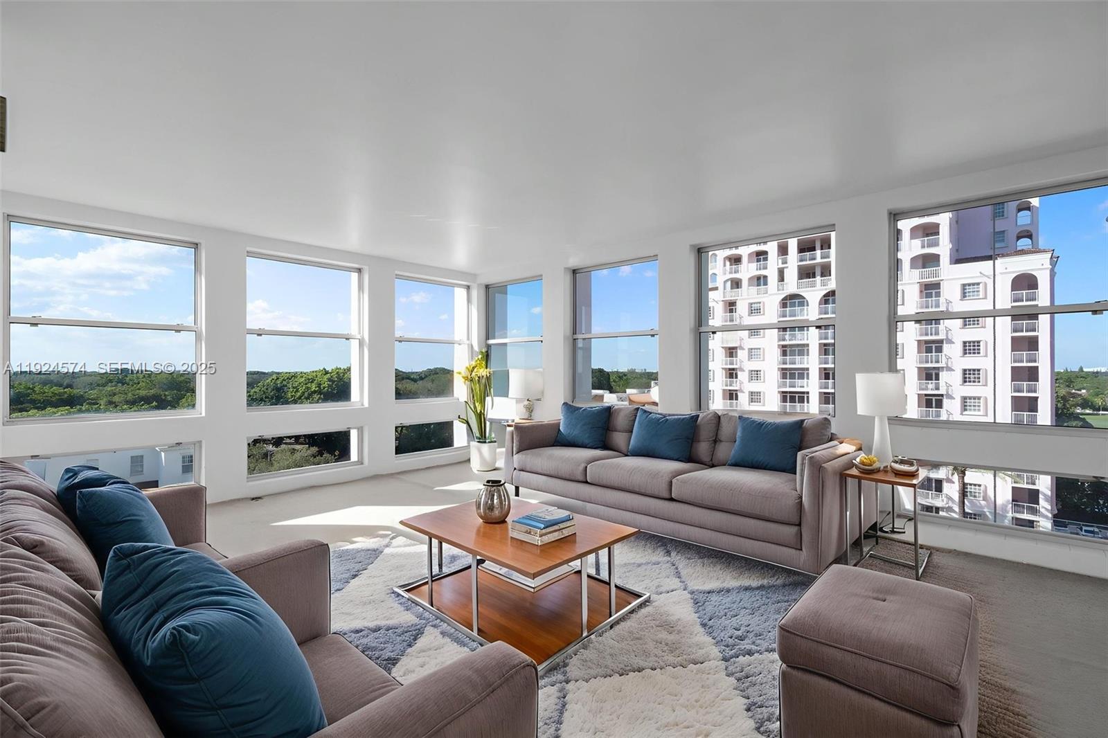 700 Biltmore Way, Unit 710 Coral Gables, FL 33134 - Photo 11 of 41 a living room with furniture and a large window