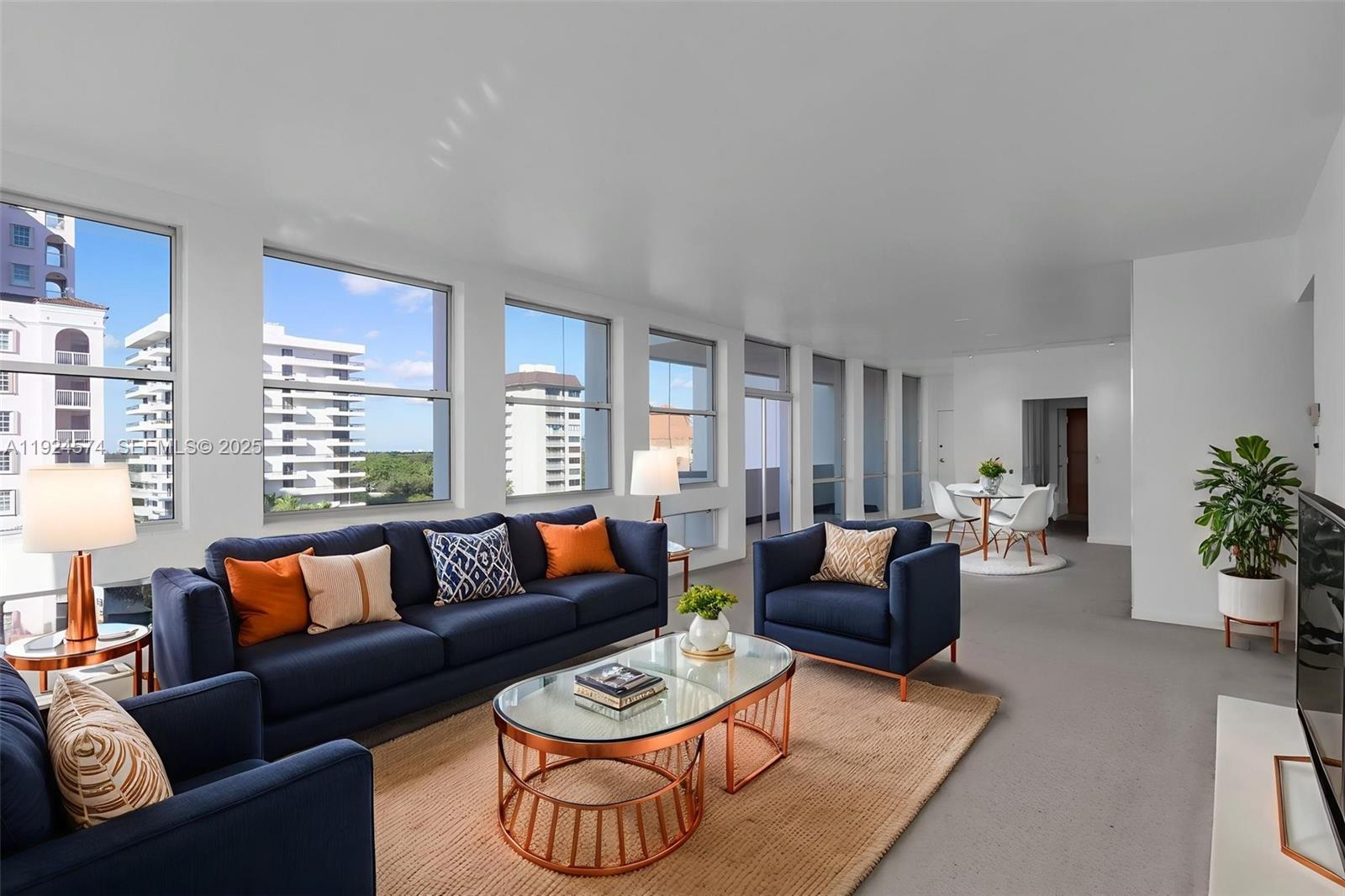 700 Biltmore Way, Unit 710 Coral Gables, FL 33134 - Photo 12 of 41 a living room with furniture potted plant and a large window
