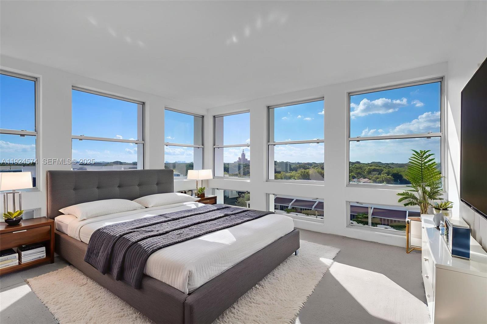 700 Biltmore Way, Unit 710 Coral Gables, FL 33134 - Photo 14 of 41 a bedroom with a large bed and a large window with balcony view