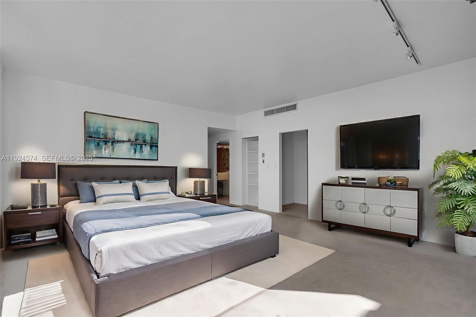 700 Biltmore Way, Unit 710 Coral Gables, FL 33134 - Photo 26 of 41 a bedroom with a bed and a flat screen tv