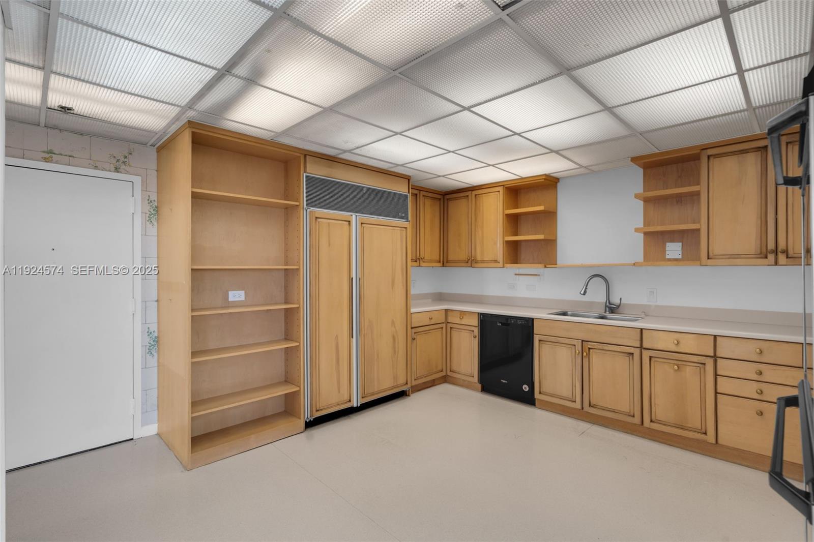 700 Biltmore Way, Unit 710 Coral Gables, FL 33134 - Photo 27 of 41 a large white kitchen with a sink and dishwasher a refrigerator with white cabinets