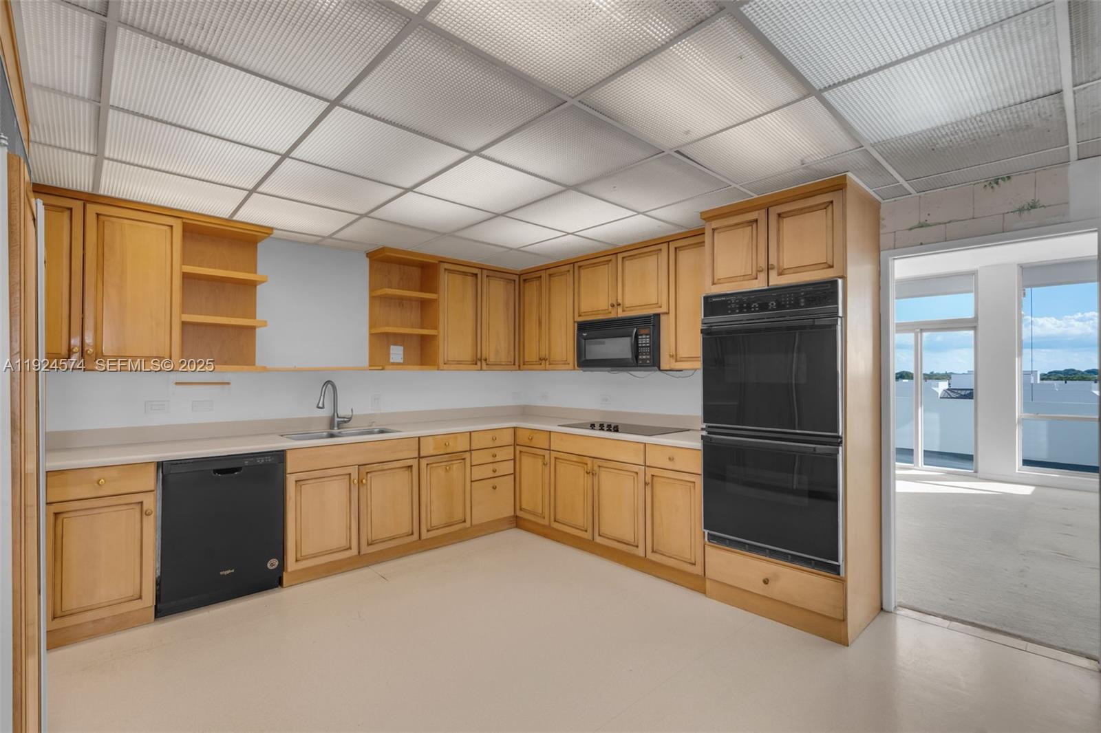 700 Biltmore Way, Unit 710 Coral Gables, FL 33134 - Photo 28 of 41 a kitchen with stainless steel appliances granite countertop a refrigerator a sink dishwasher a oven with white cabinets and countertops