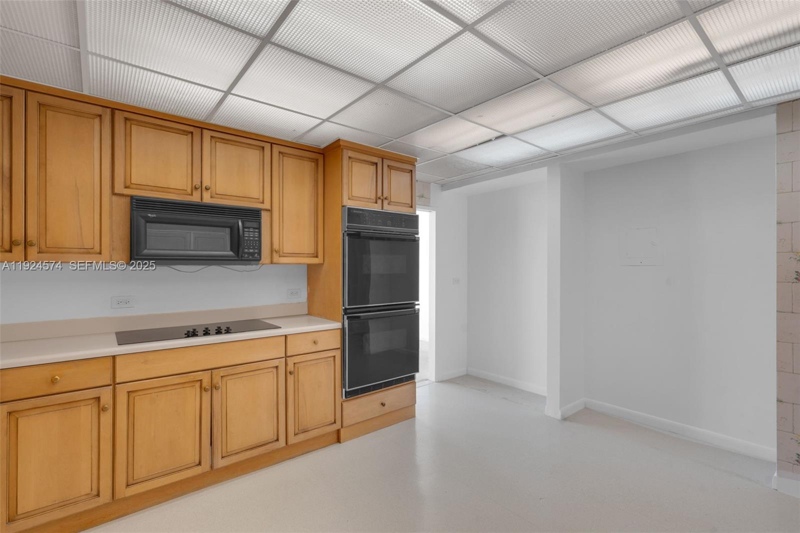 700 Biltmore Way, Unit 710 Coral Gables, FL 33134 - Photo 29 of 41 a kitchen with white cabinets and stainless steel appliances