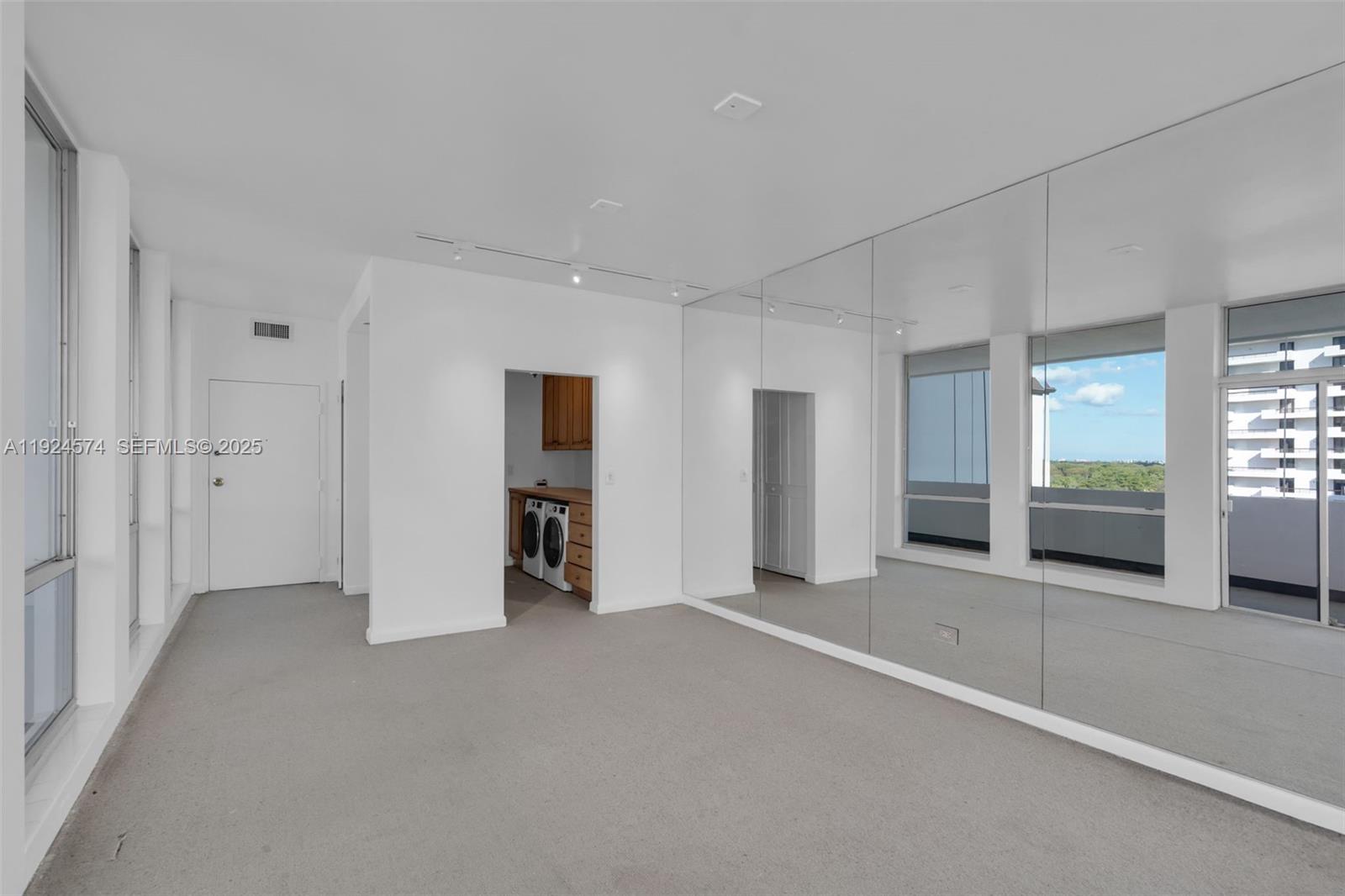 700 Biltmore Way, Unit 710 Coral Gables, FL 33134 - Photo 10 of 41 an empty room with closet and bathroom