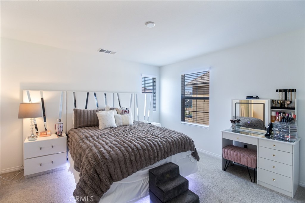 2448 Powell Drive Rialto, CA 92377 - Photo 11 of 30 a bedroom with a bed and a dresser