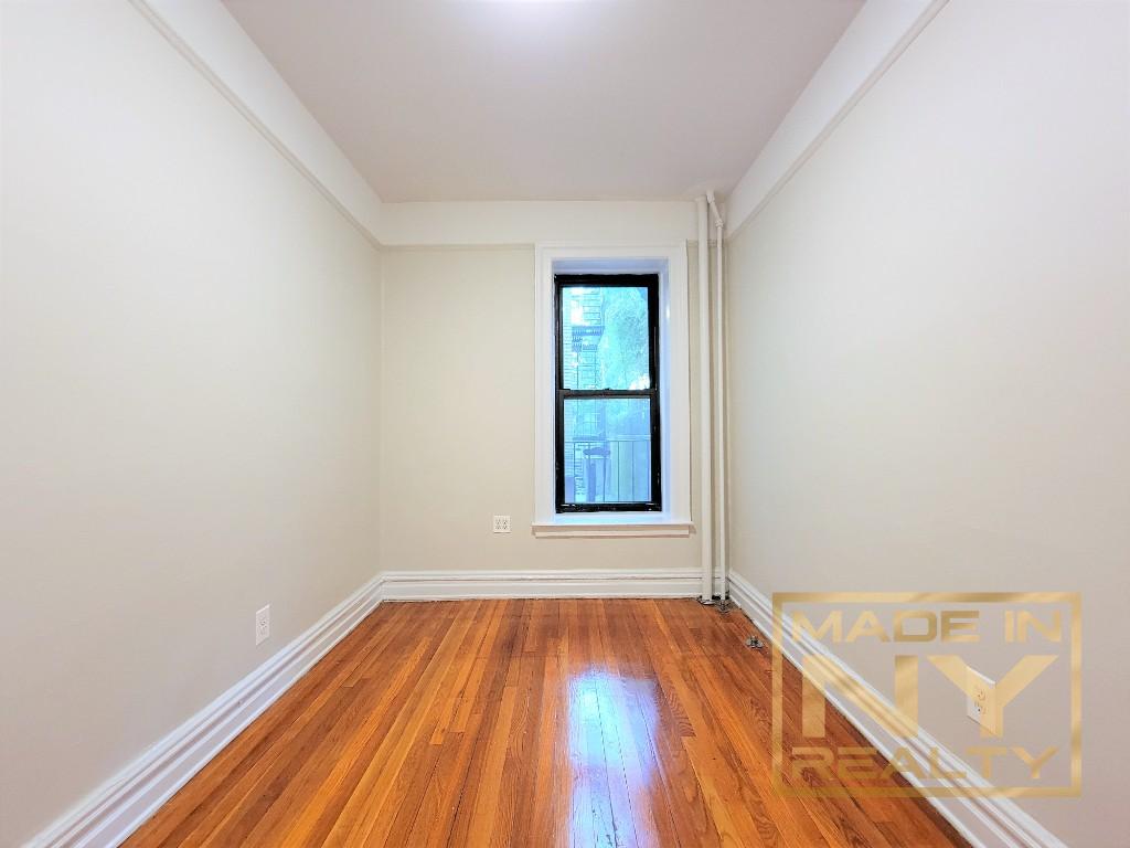 29-07 31st Avenue, Unit 1E Queens, NY 11106 - Photo 6 of 7 a view of a room with wooden floor and window