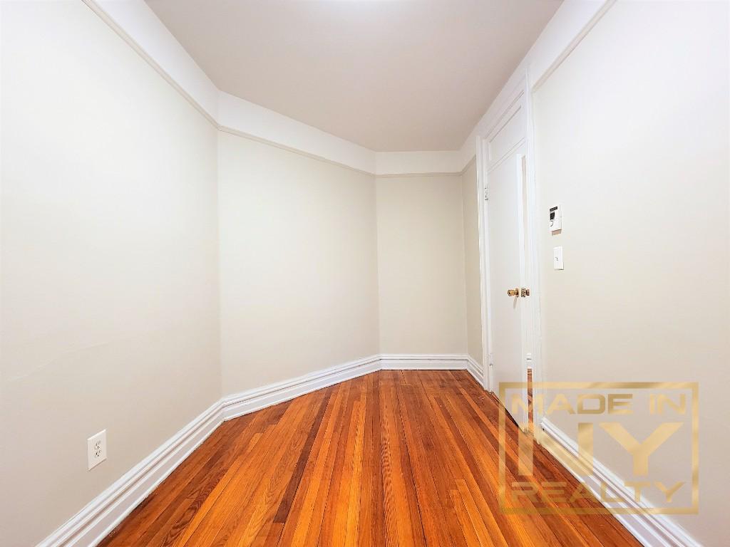 29-07 31st Avenue, Unit 1E Queens, NY 11106 - Photo 7 of 7 a view of a room with wooden floor