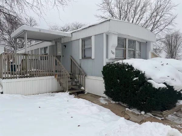 a view of a house with a snow in the yard