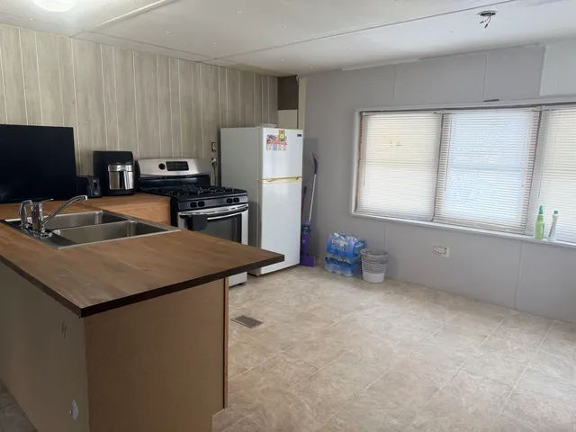 a kitchen with refrigerator and window