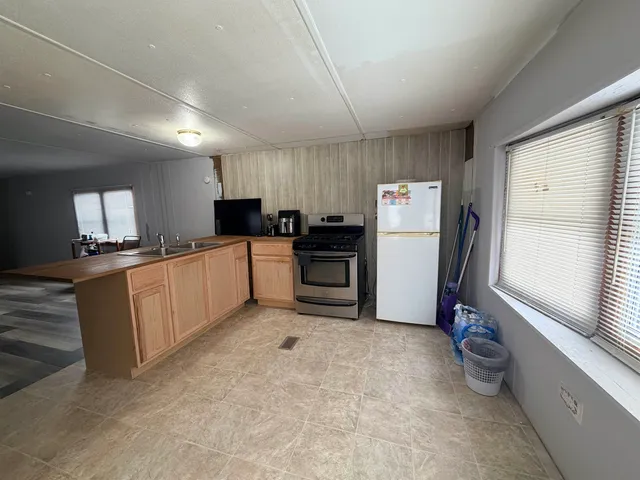 a kitchen with a refrigerator sink and stove