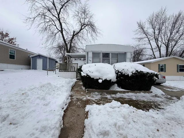 a view of a house with a yard covered in snow