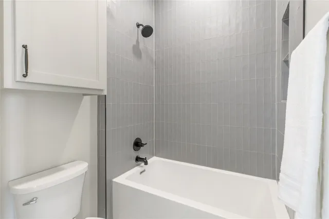 a white bath tub sitting next to a toilet