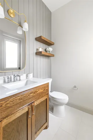a bathroom with a sink a toilet and mirror