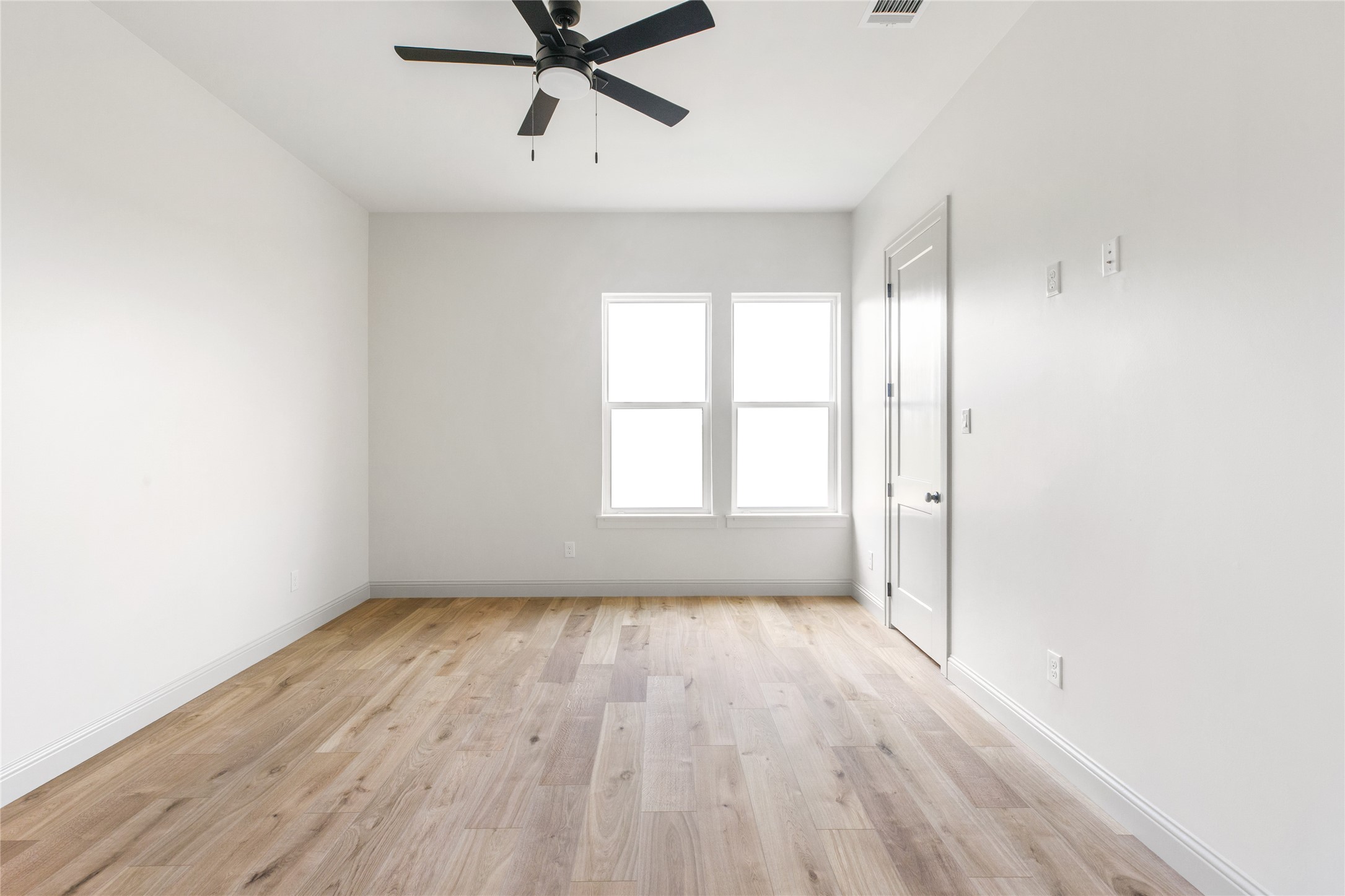 1355 Bluebonnet Ridge Drive Chappell Hill, TX 77426 - Photo 26 of 37 an empty room with wooden floor fan and windows