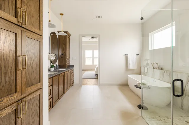 a bathroom with a double vanity sink toilet and shower