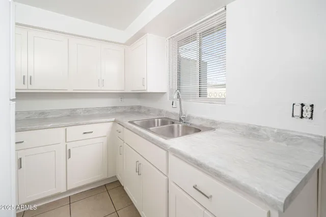 a kitchen with a sink cabinets and window