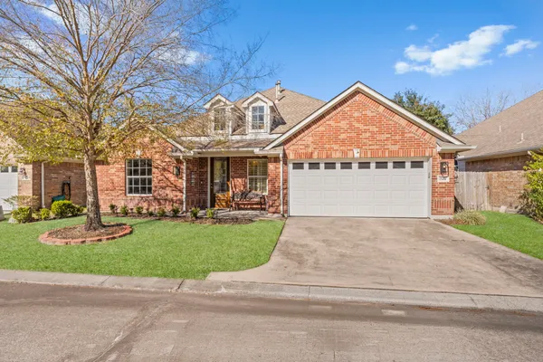 a view of a house with a yard and garage