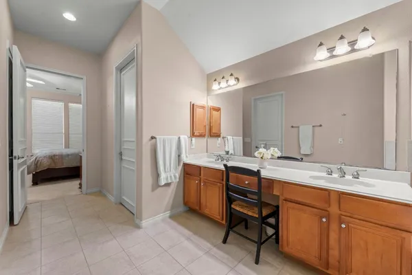 a en suite bathroom with a double vanity sink and a mirror