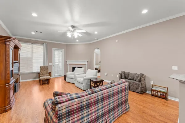 a living room with furniture fireplace and wooden floor