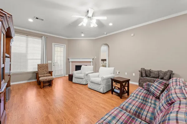 a living room with furniture and a fireplace