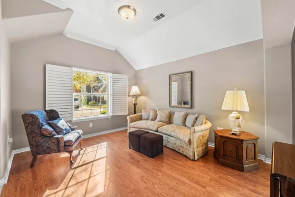 a living room with furniture fireplace and a large window