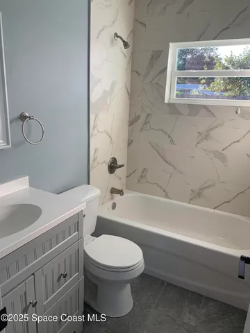 a bathroom with a toilet a sink and bathtub