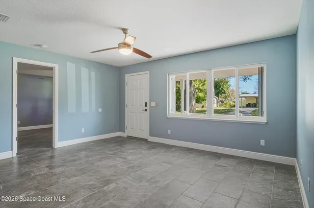 an empty room with windows and closet