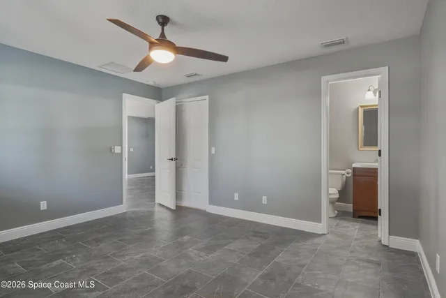 wooden floor in an empty room and a bathroom