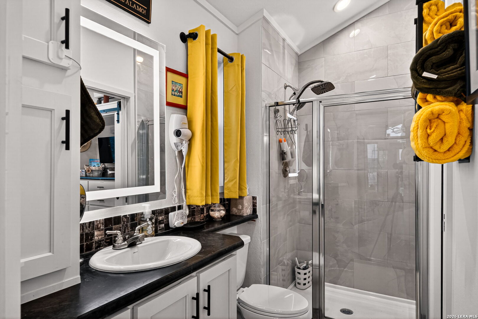 5386 Ranch Road 1376, Unit 64 Fredericksburg, TX 78624 - Photo 13 of 45 a bathroom with a sink vanity mirror and shower