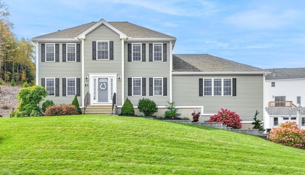 a front view of a house with a yard