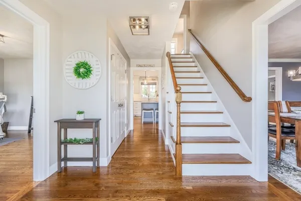 a view of entryway and hall with wooden floor