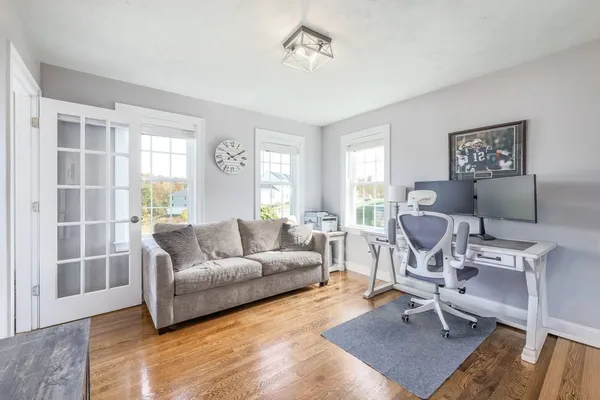 a living room with furniture a rug and a window