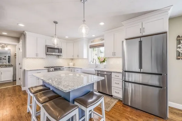 a kitchen with a refrigerator a sink and a stove
